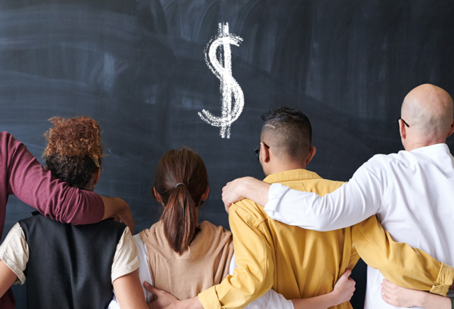 A diverse group of people standing with arms around each other, facing a chalkboard with a dollar sign drawn on it.