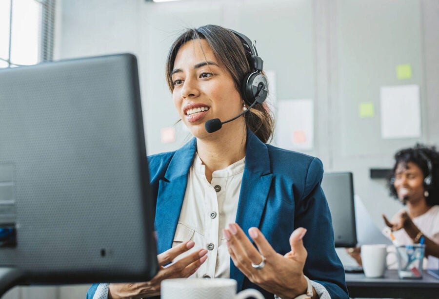 Woman in a call center talking to customers by headset